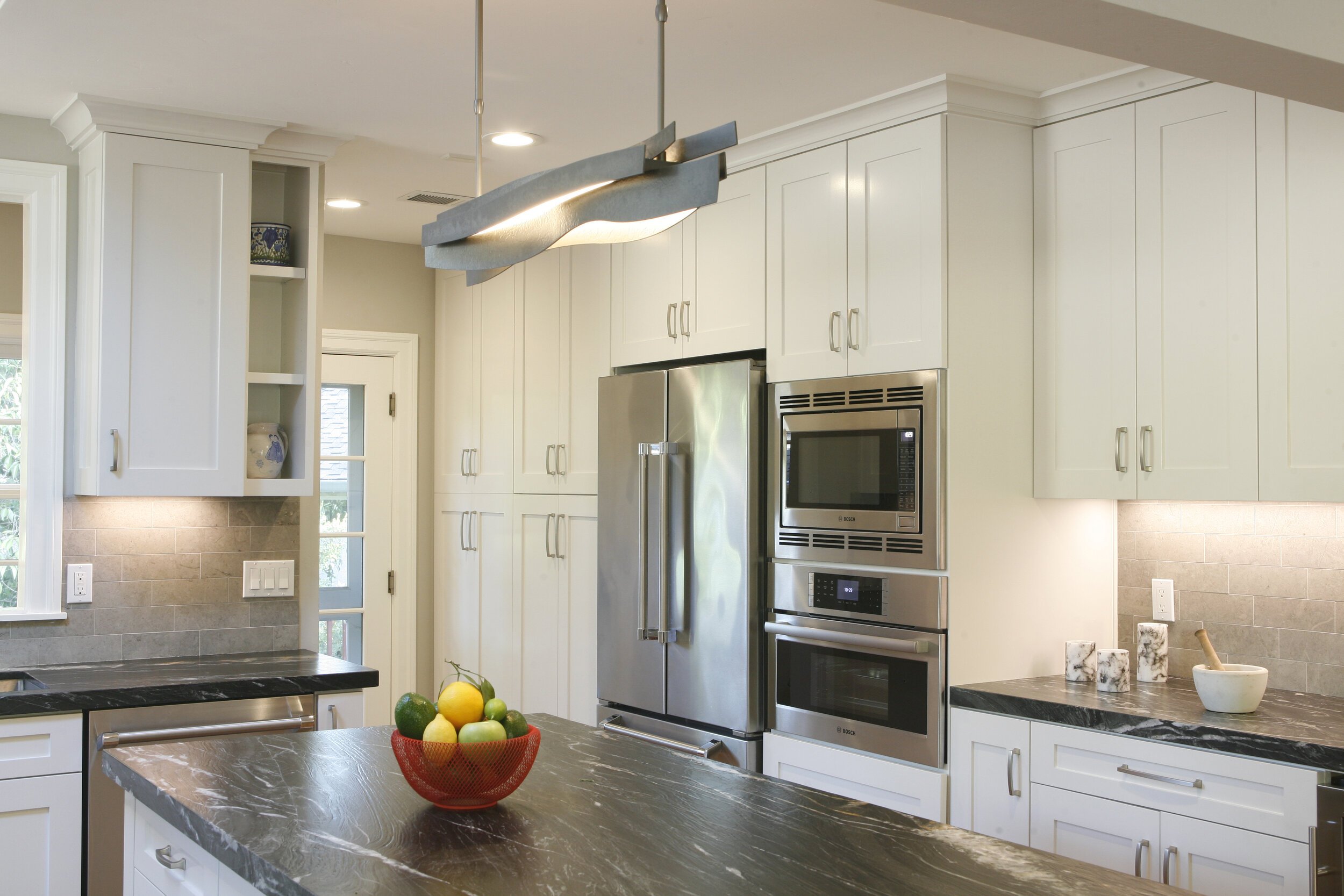 What was once a tight galley kitchen and laundry space is now a bright, open and airy space that feels warm and inviting.