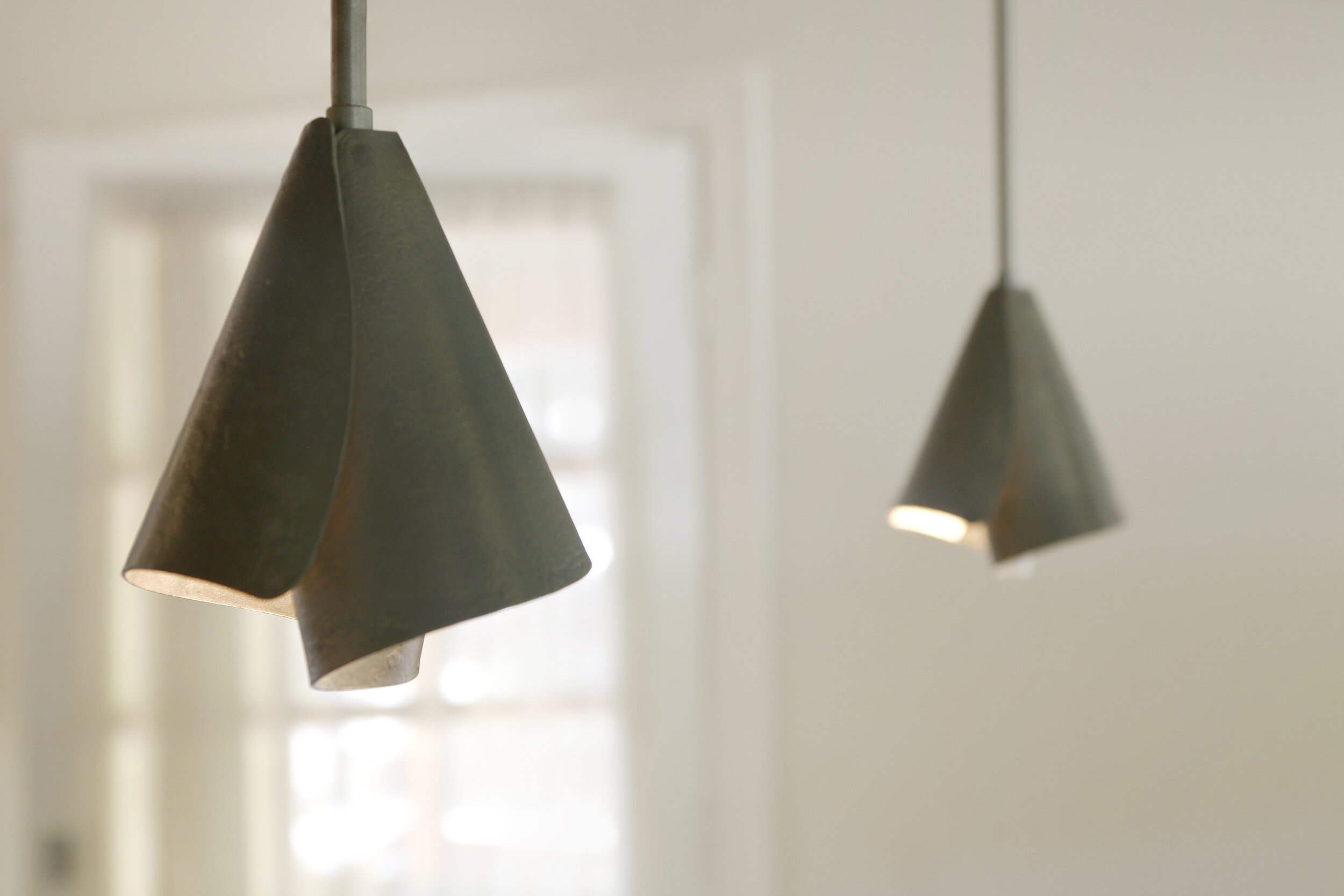 The gorgeous steel pendants above the dining table are rolled steel and another sculptural nod to the industrious tinkerer who resides here.