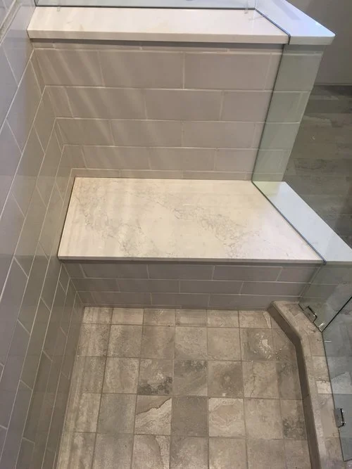 A bench seat incorporated into this tight shower space is useful for any injury rehabilitation time that might be needed 
