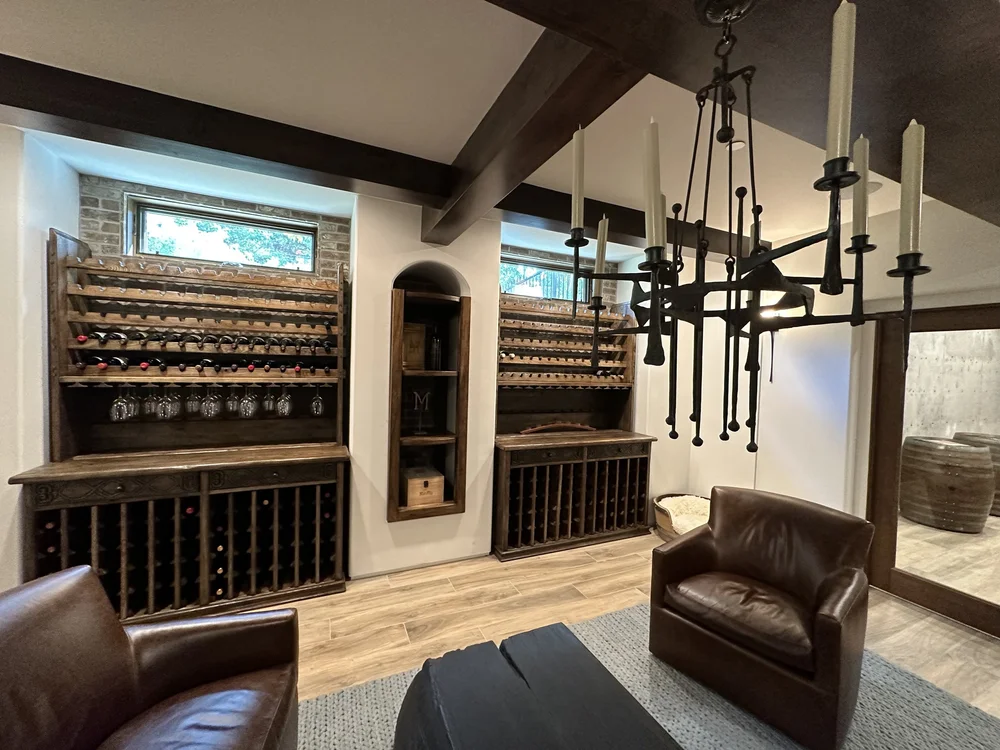  A forged iron chandelier is a nod to the family’s ranching history and a centerpiece in the wine cellar. 