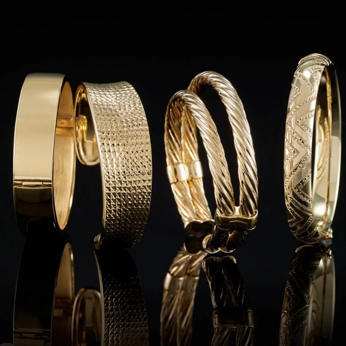 Luxurious bangles crafted in 14K yellow gold formed around precious sterling silver. Stack em up high!
