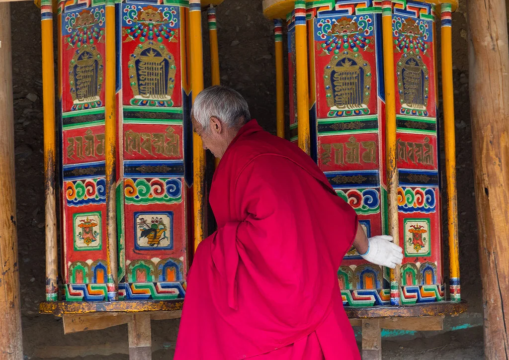 Tibetan Monk Turning Prayer Wheel in Labrang Monastery