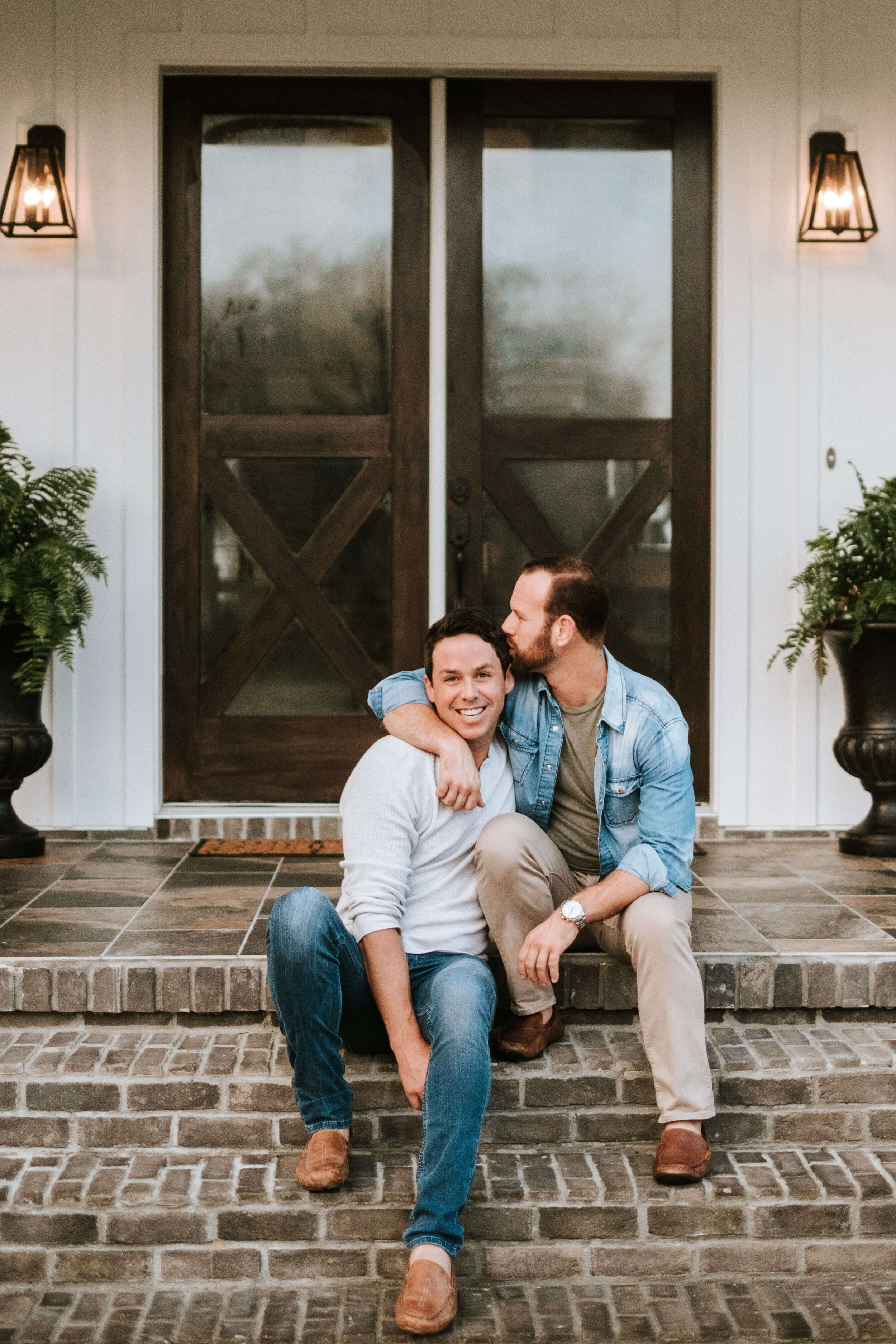 Men styled kissing on steps