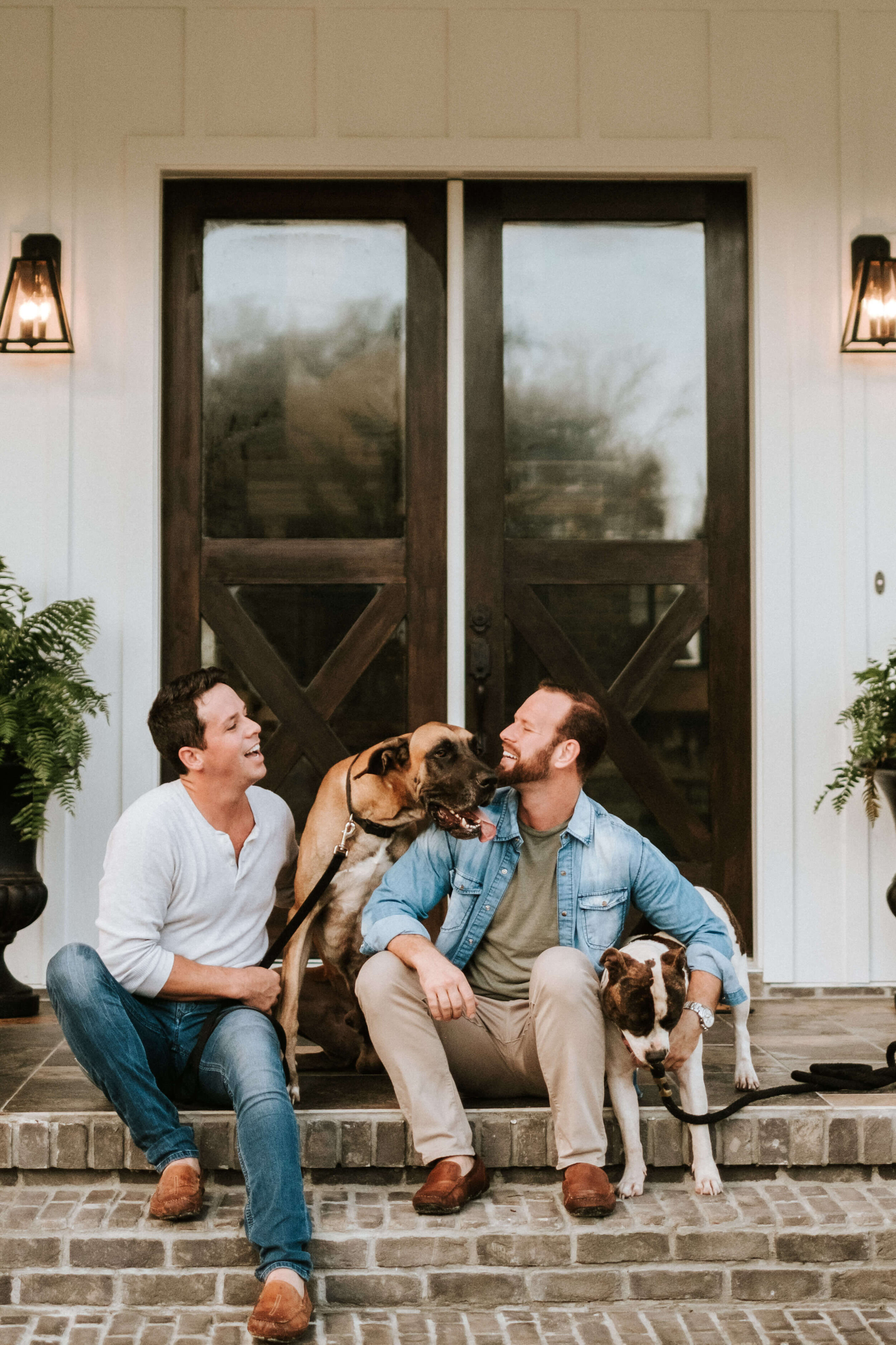 Men styled holding their dogs