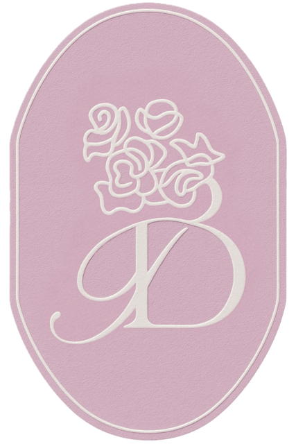 Booked event planning brand mark featuring a blush background and floral monogram