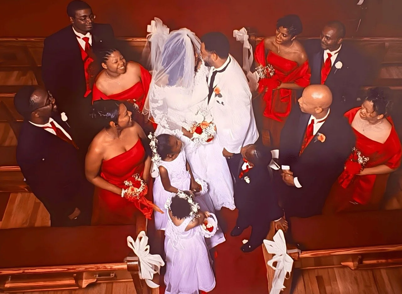 Bride and groom surrounded by their wedding party inside a church after the ceremony
