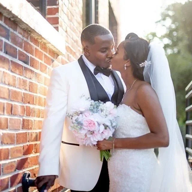 Bride and groom sharing a kiss as they exit the wedding ceremony