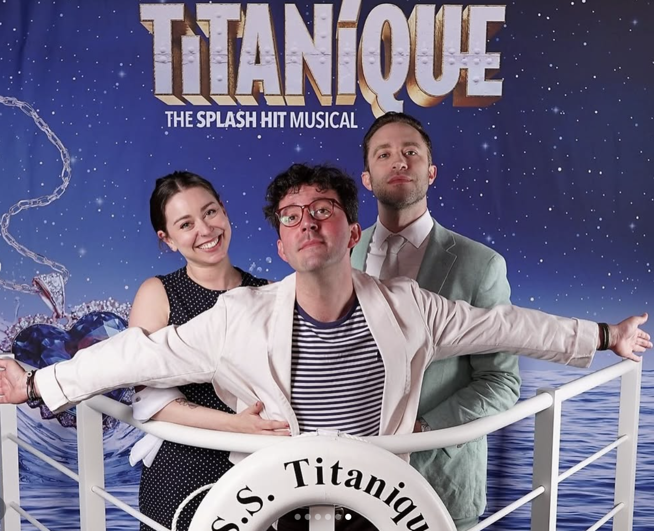 three people recreating the jack and rose post from titanic at the titanique step and repeat (two people are playing jack and I am playing rose)