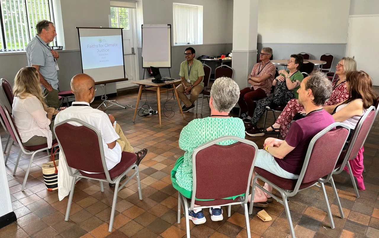Several seated people watch a presentation being made at a previous FUSE Festival