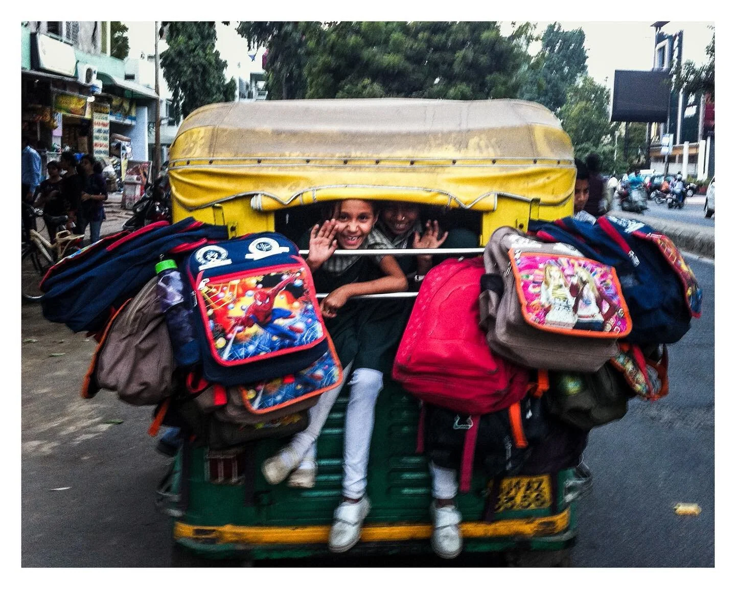School Run Rickshaw - this photo is out of focus / blurry and generally of poor quality - but I love it. 

When in Ahmedabad - India, my wife pointed out this rickshaw of school girls waving at me, I had about 3 seconds to get my then top of the rang
