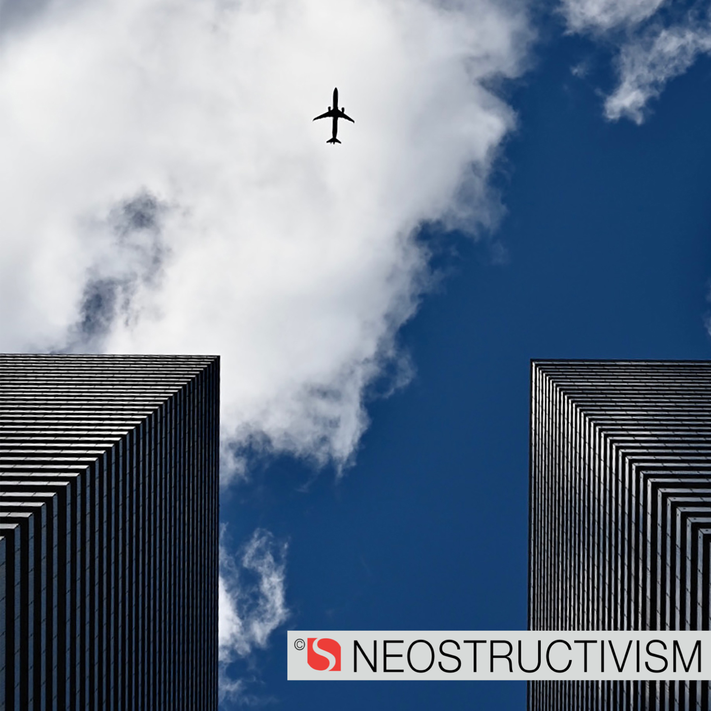 airplane flying between two high rise buildings