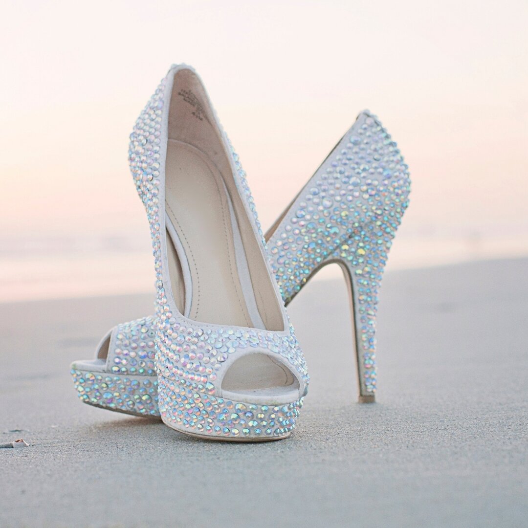 Choosing the right shoes for your beach wedding is all about balancing style and comfort. While these stunning, crystal-embellished heels may be perfect for portraits and the reception, consider switching to flat sandals or going barefoot for the cer