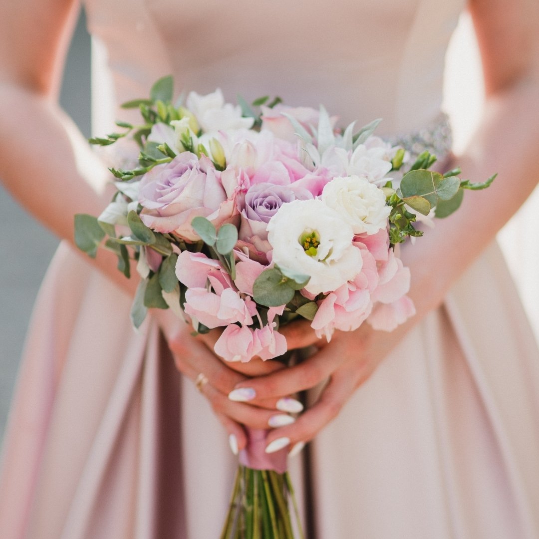 Accent your wedding decor with hues that harmonize; your wedding party florals should complement, not compete. Bring fabric swatches to your floral consultation to craft a palette that echoes the grace of their attire. After all, it's the subtle touc