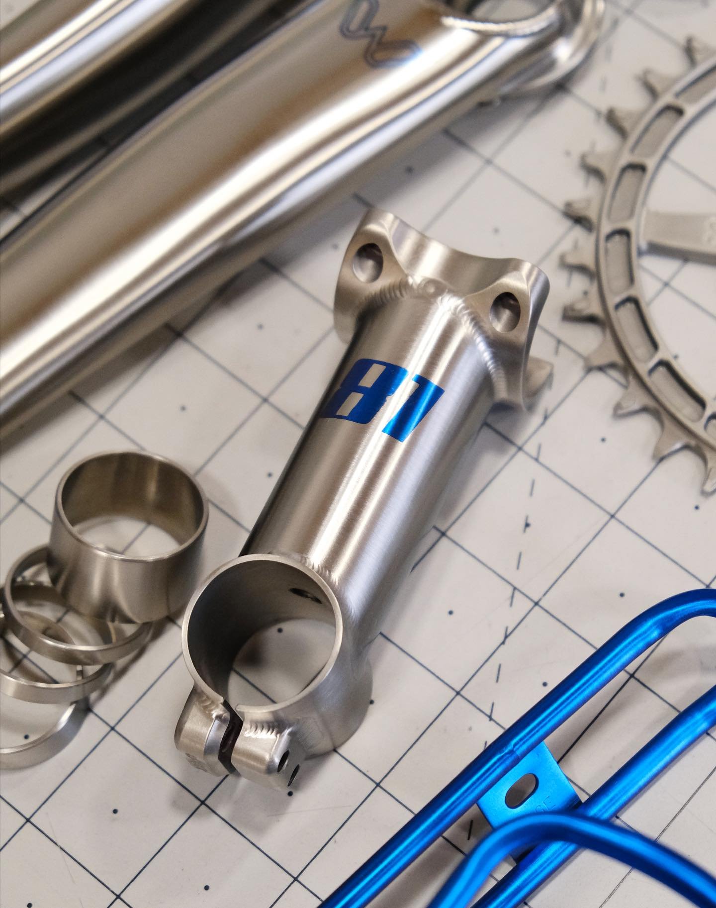 A little kit of refinished components for Ty: he sent in his Moots stem and spacers for a refinish in a smooth brushed finish, and we added a special racing number in blue to match the laser etched graphics on his eeWings and Thomson seatpost. Add in