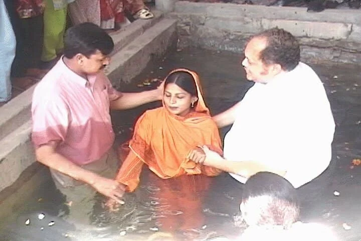 Apostle Barr baptizing a woman in Pakistan.
