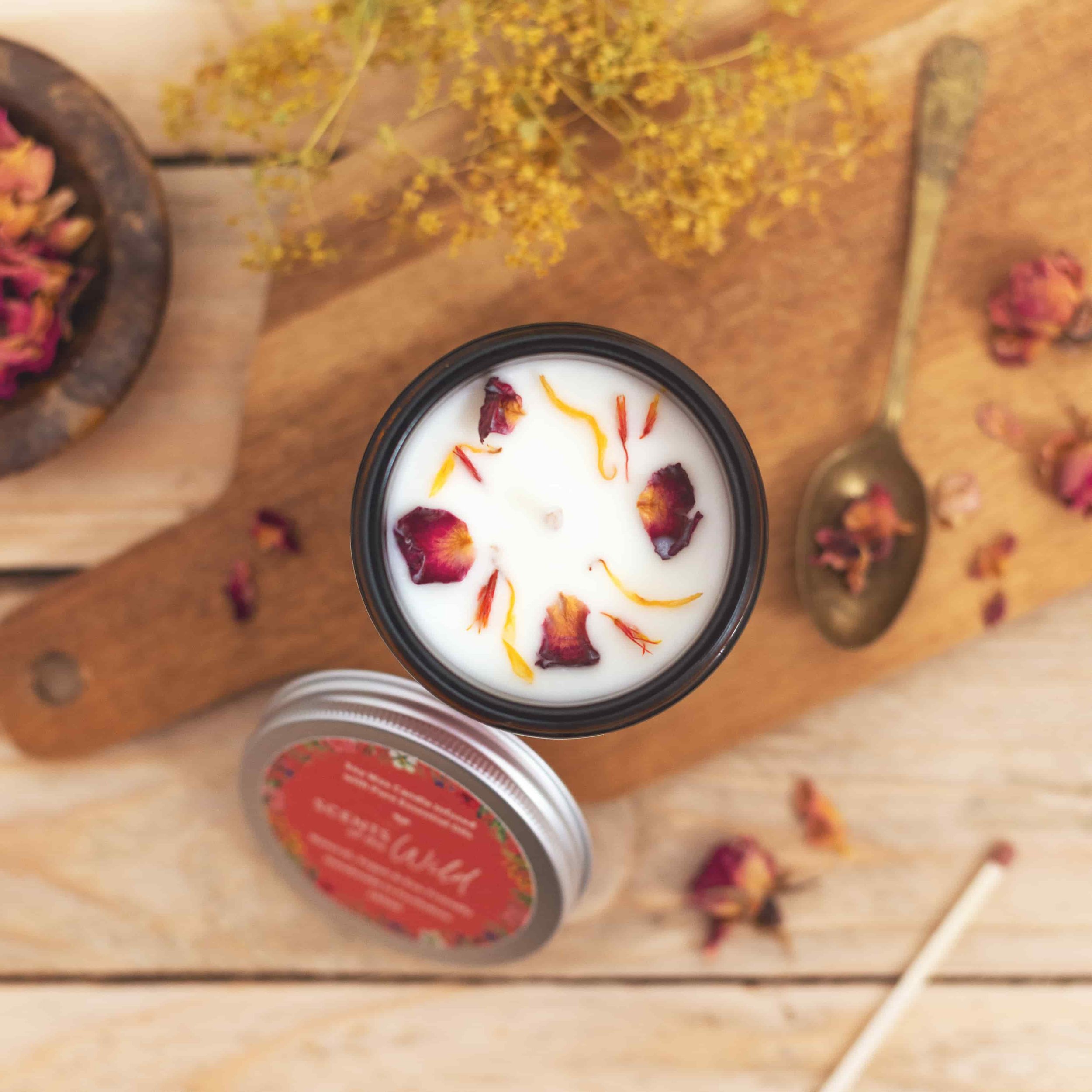 Top of natural soy wax candle decorated with rose petals and dried botanicals.jpg