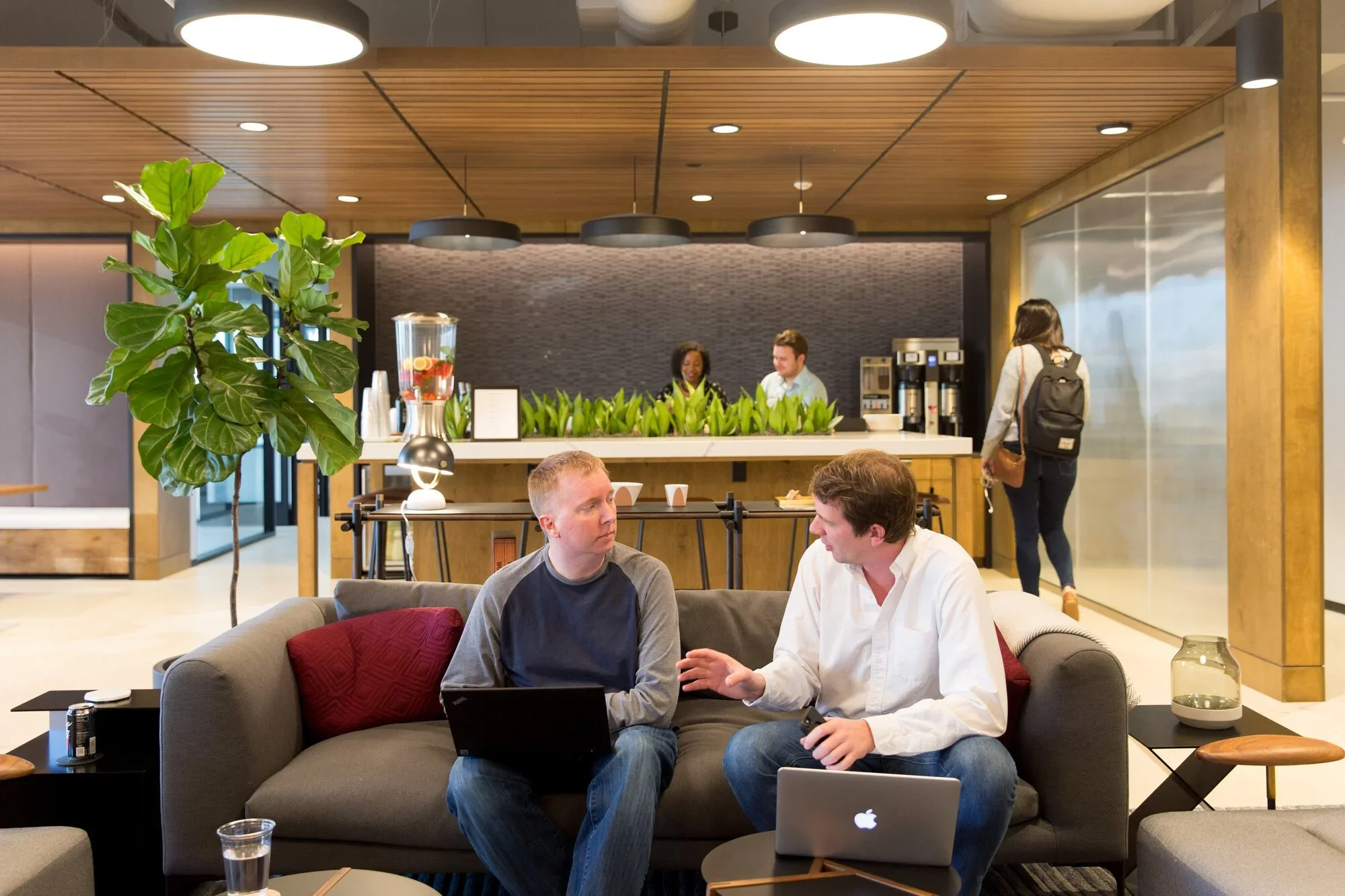 Two people talking in a lounge area