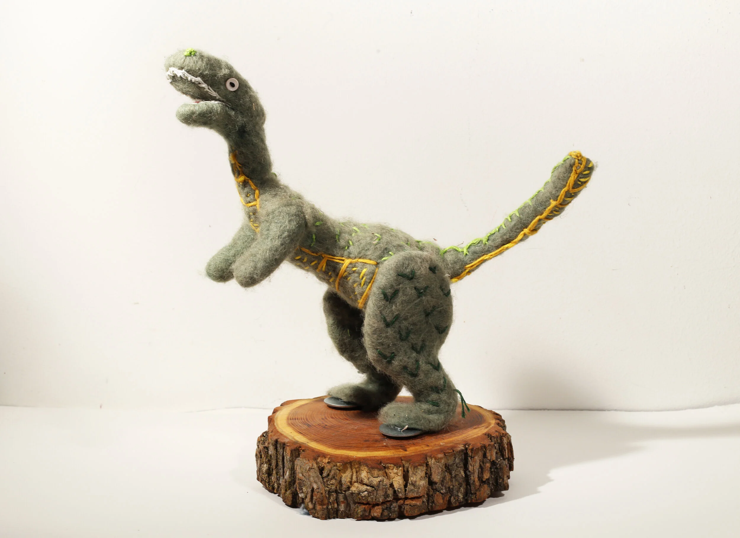 T-Rex, 2015, Aluminum Armature Wire, Epoxy Putty, Needle Felted Wool, Embroidery Floss, Buttons, Black Locust Wood Slice