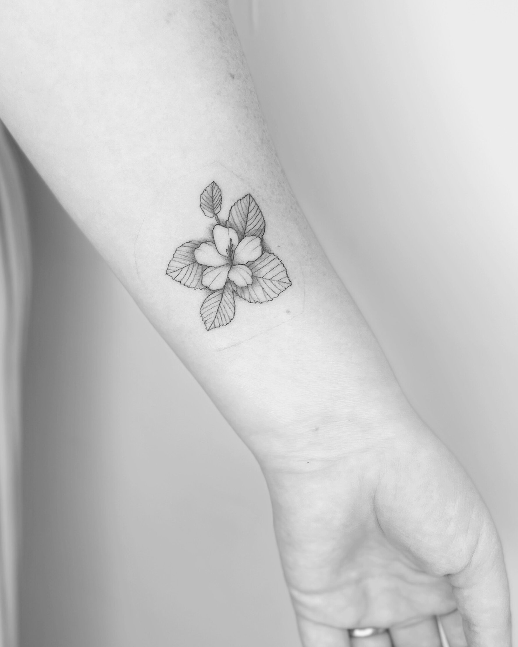 Fine line floral tattoo