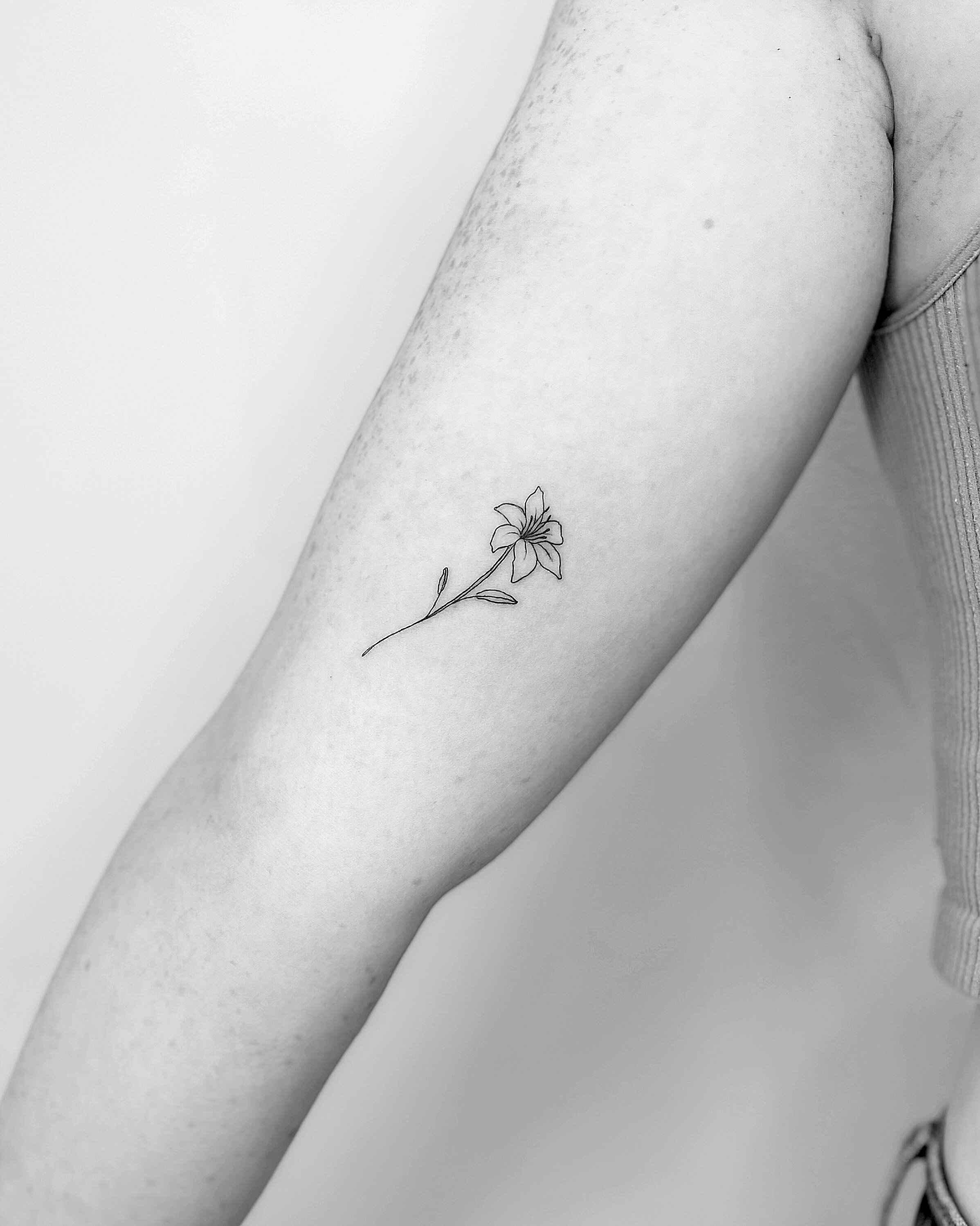 fine line tattoo of a flower