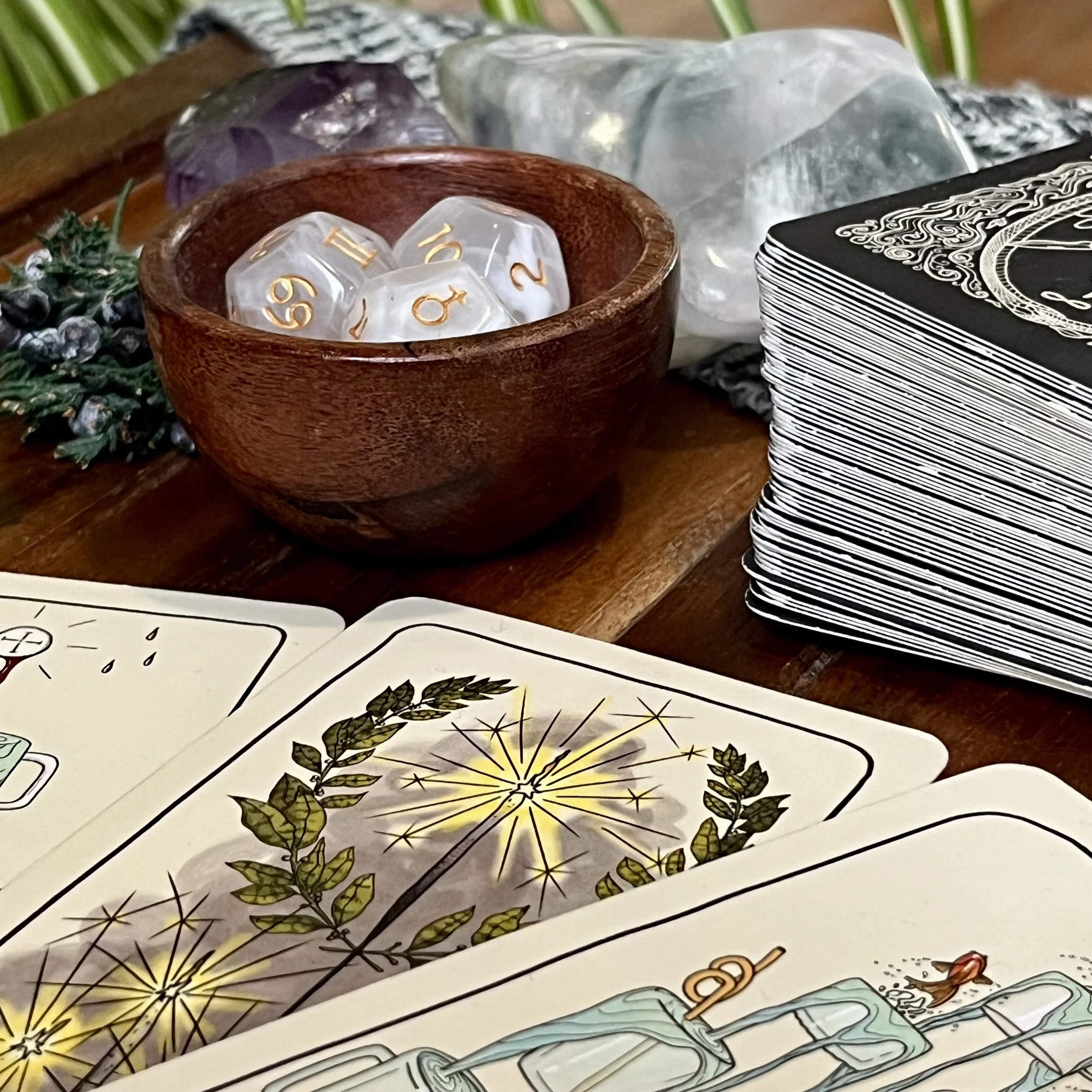 Tarot Cards and astrology dice in a wooden bowl sit on a wooden table