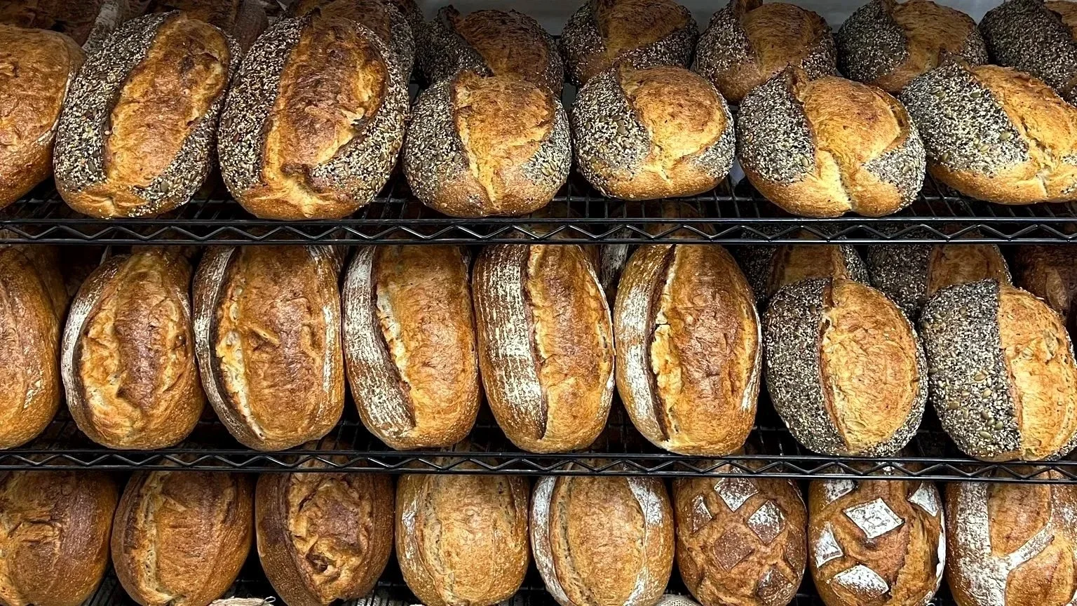 Assorted Seasalt Sourdough loaves cooling on bakery racks in Swan Reach