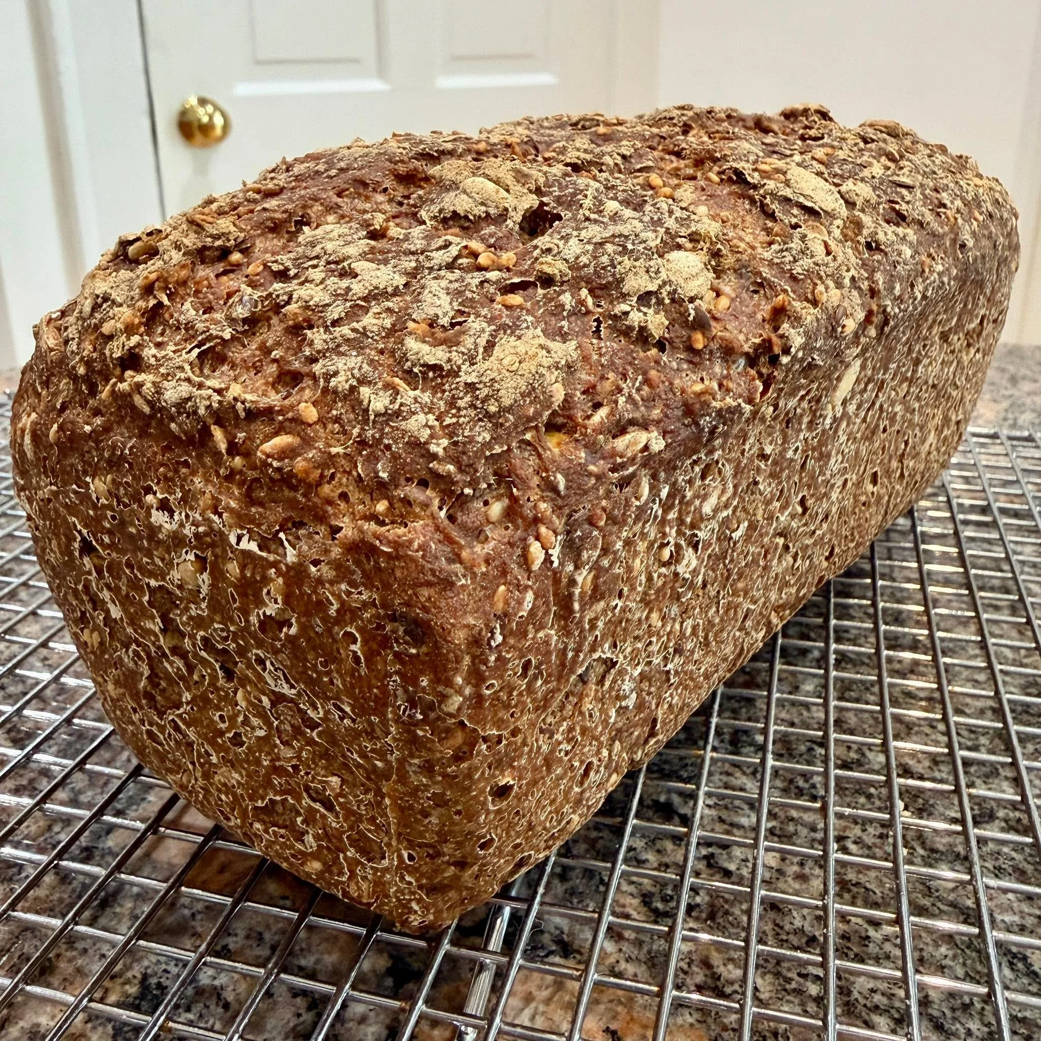 First bake of 2026! ✨ Nordic rye style gluten-free sourdough loaf. Dark, rustic, yet soft. 

Full of healthy seeds and whole grains. No added starches or gums. 😋 Delicious and good for your gut microbiome. 

Please cool soon 🙏🏻 so I can cut a slic