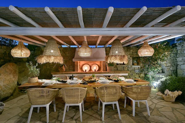 Covered outdoor dining at Villa Ioli in the evening