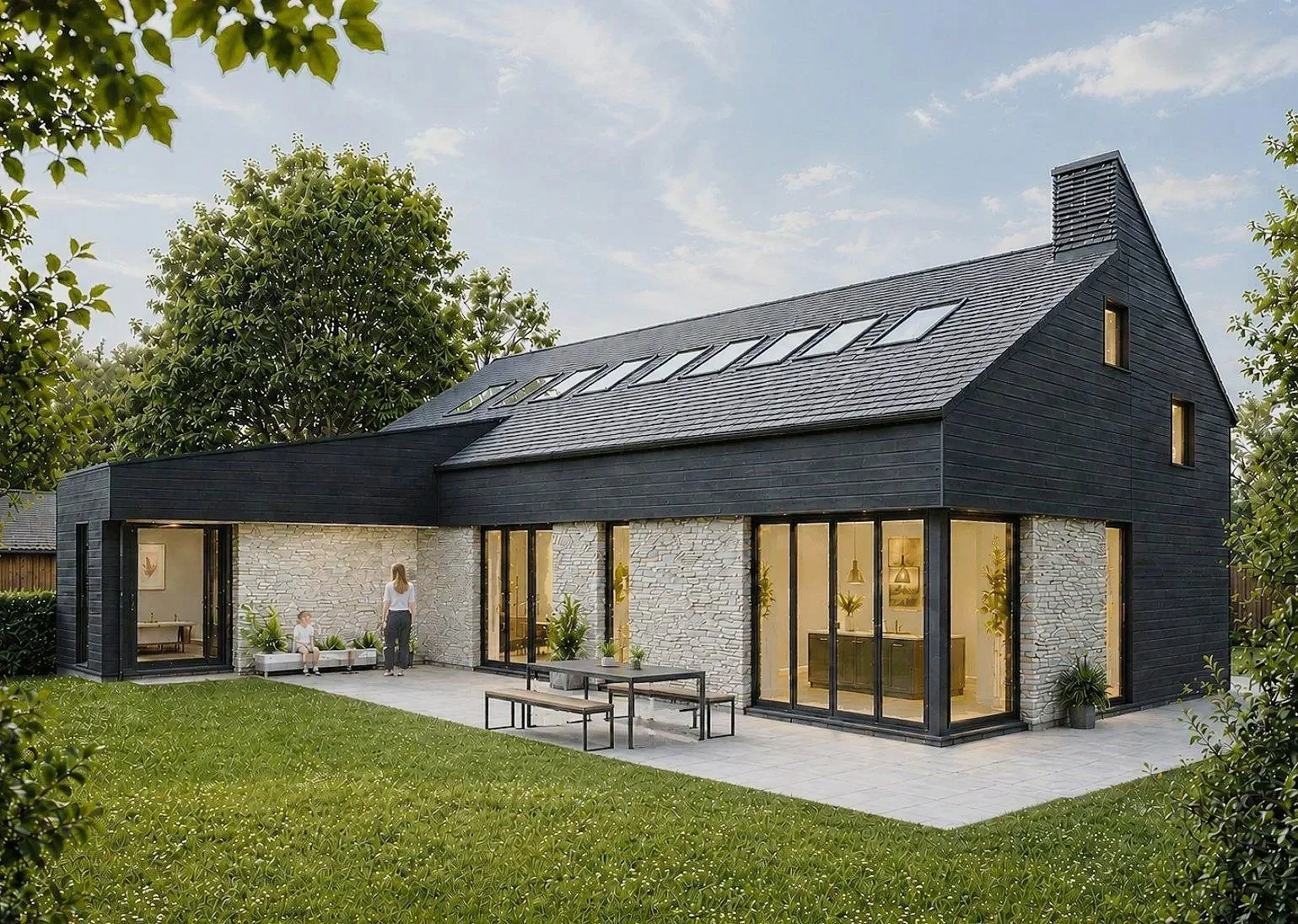 Modern two-story house with black exterior and large glass sliding doors, surrounded by green lawn and trees, with outdoor seating on patio. Eaglesham