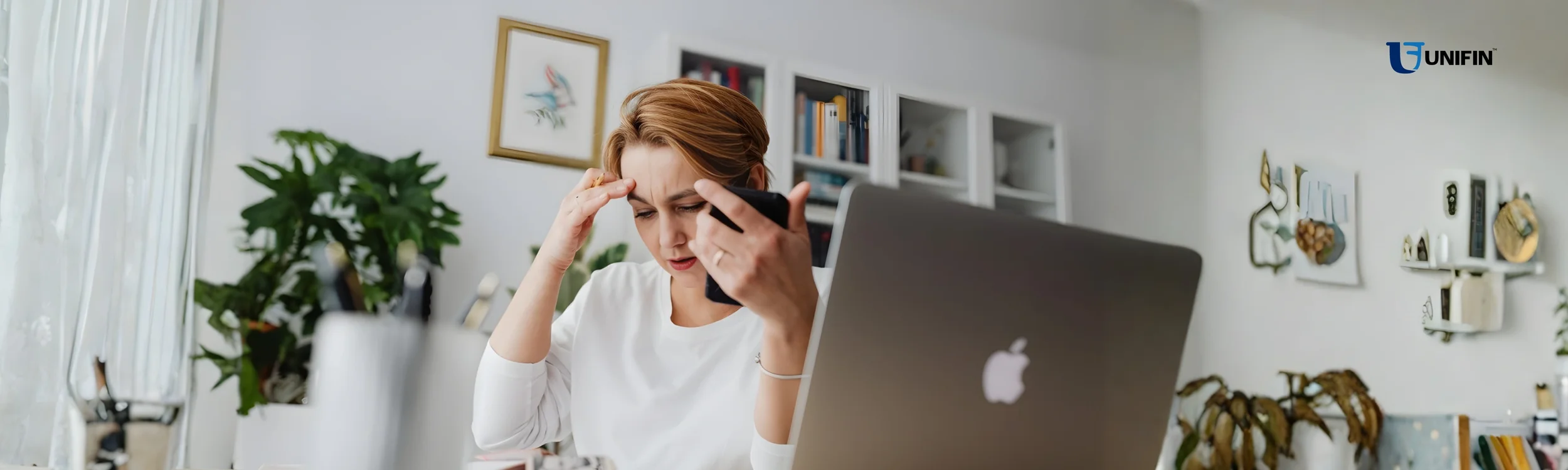 Individual using a laptop to compare debt management options and learn steps for understanding debt collection and resolving debts.