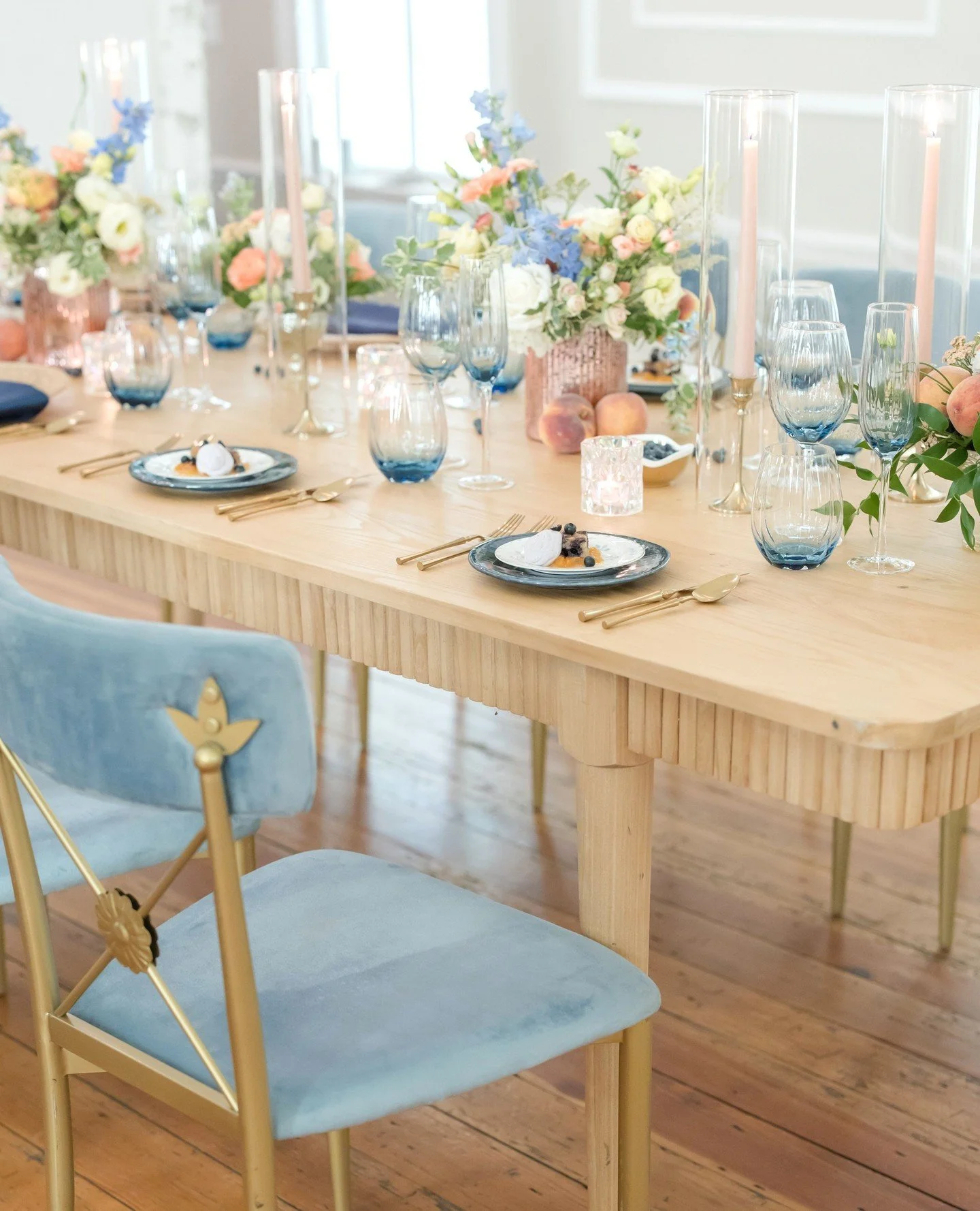 We created a Spring tablescape for @heartofncweddings using blueberries and peaches in color and detail 🫐🍑⁠
⁠
&ldquo;When a client comes to us with a vision, we don&rsquo;t just execute it; we expand upon it, finding the best florist, caterer, rent