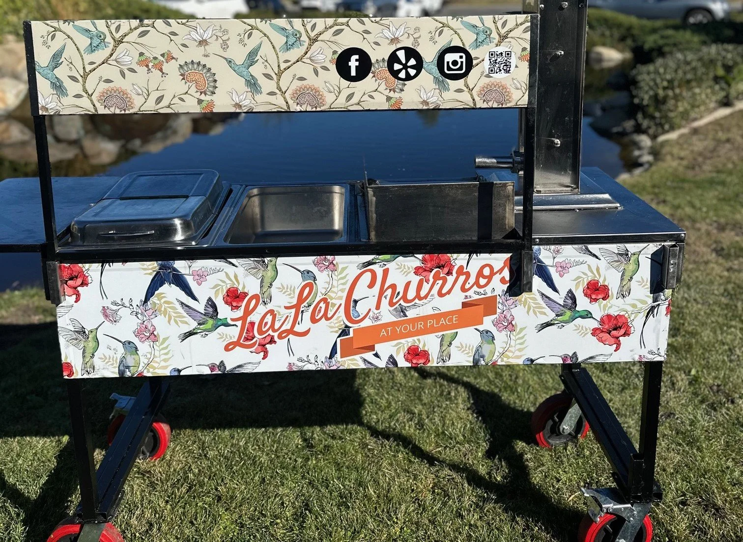 A custom mobile churro cart with artisan branding for on-site live dessert catering