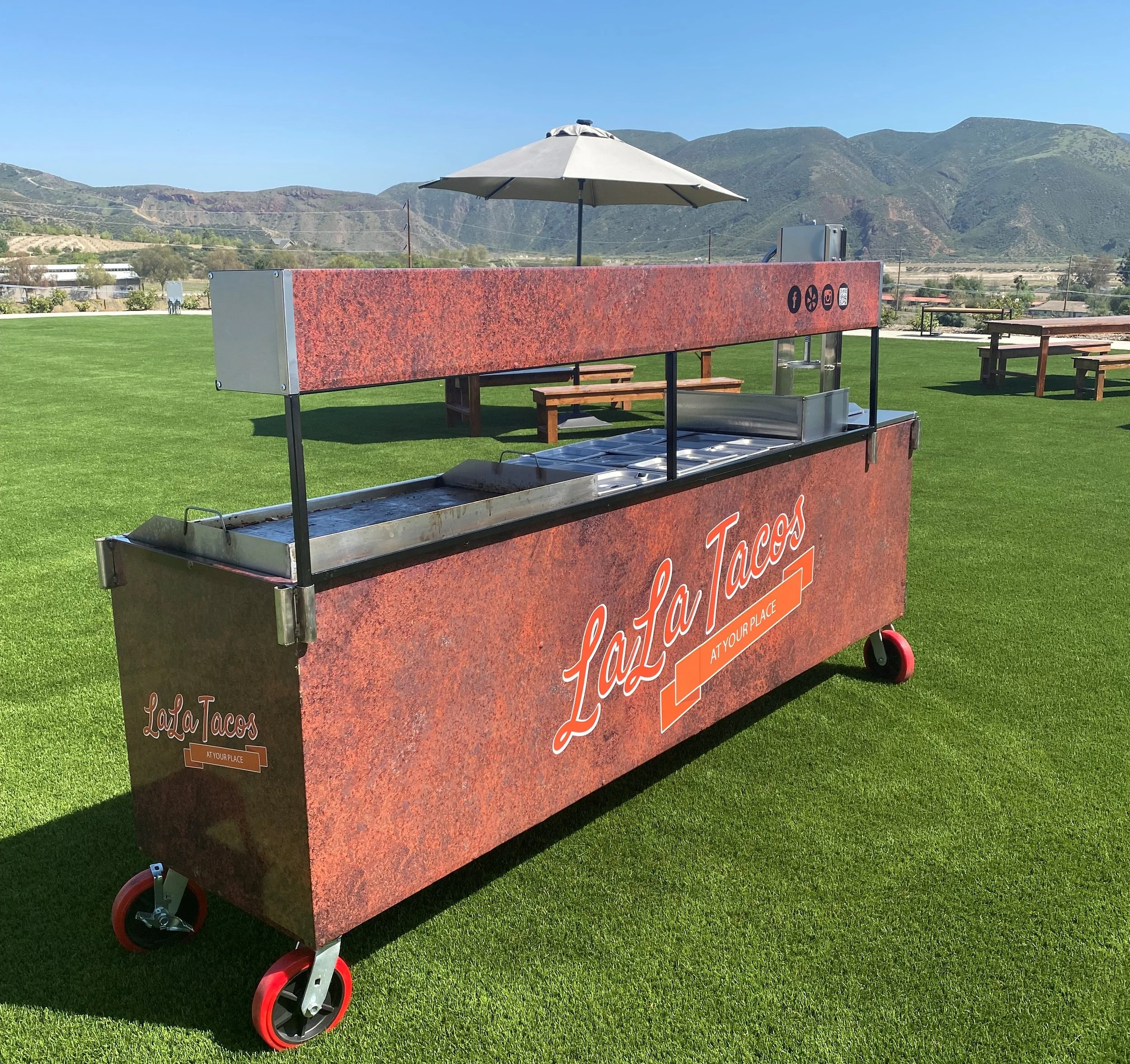 Taco catering in Santa Ana featuring a professional on-site taco cart, authentic Mexican tacos cooked fresh for guests, homemade salsas, and full-service event catering by LaLa Tacos.