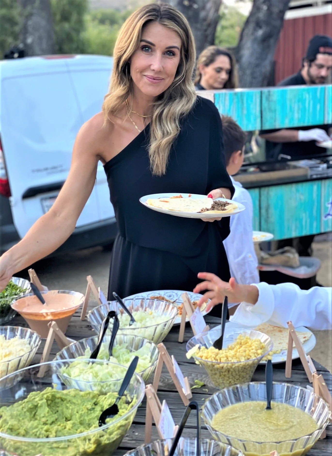 Guests enjoying an elite on-site taco bar at a high-end private party
