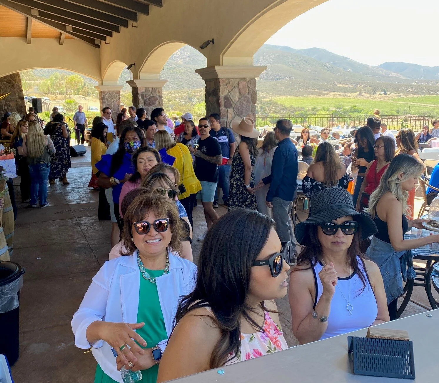 Guests enjoying on-site taco catering by LaLa Tacos at Emerald Creek Winery with scenic vineyard and mountain views in the background.