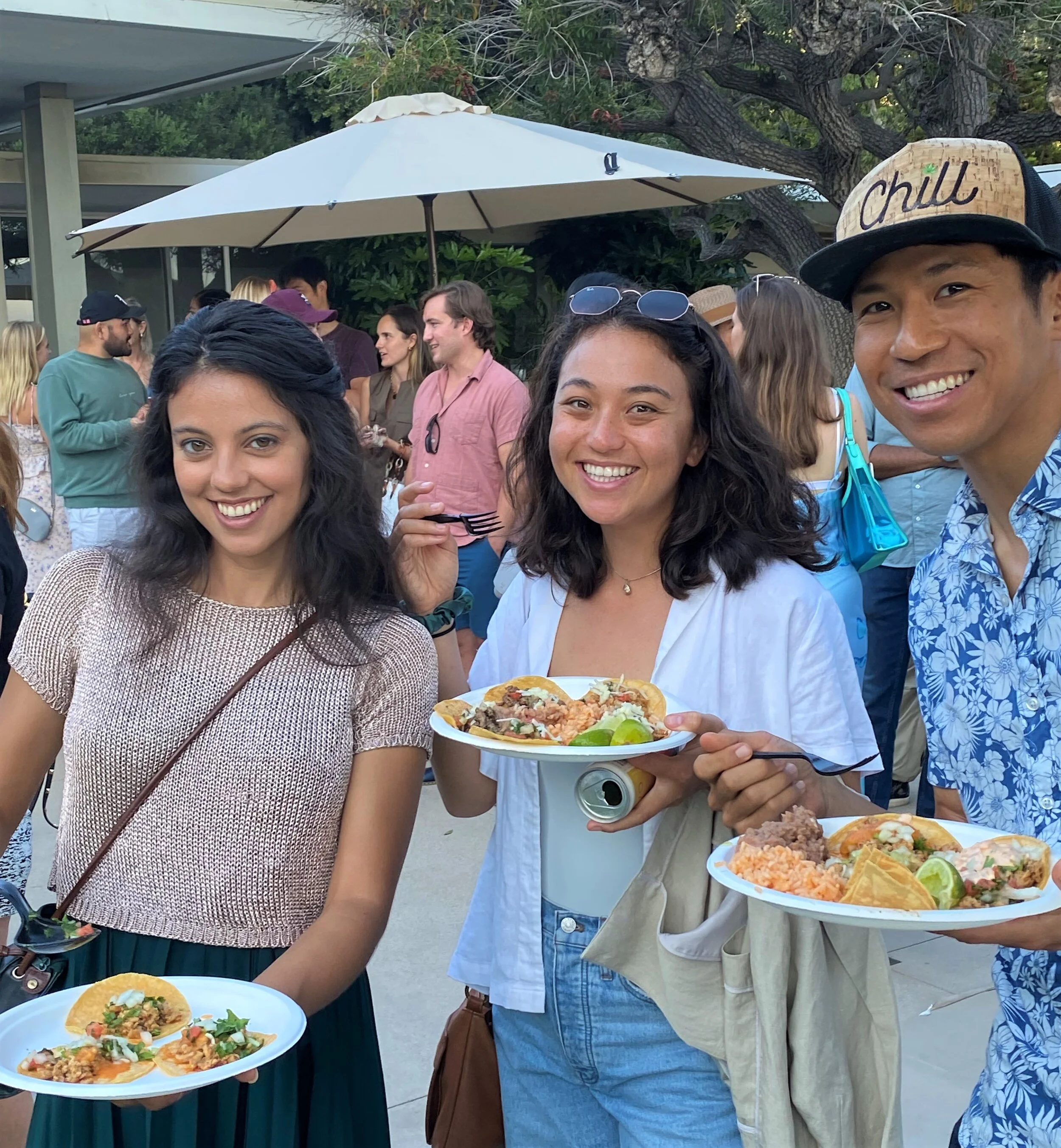 Guests enjoying fresh tacos and taco bar catering at an outdoor private event.