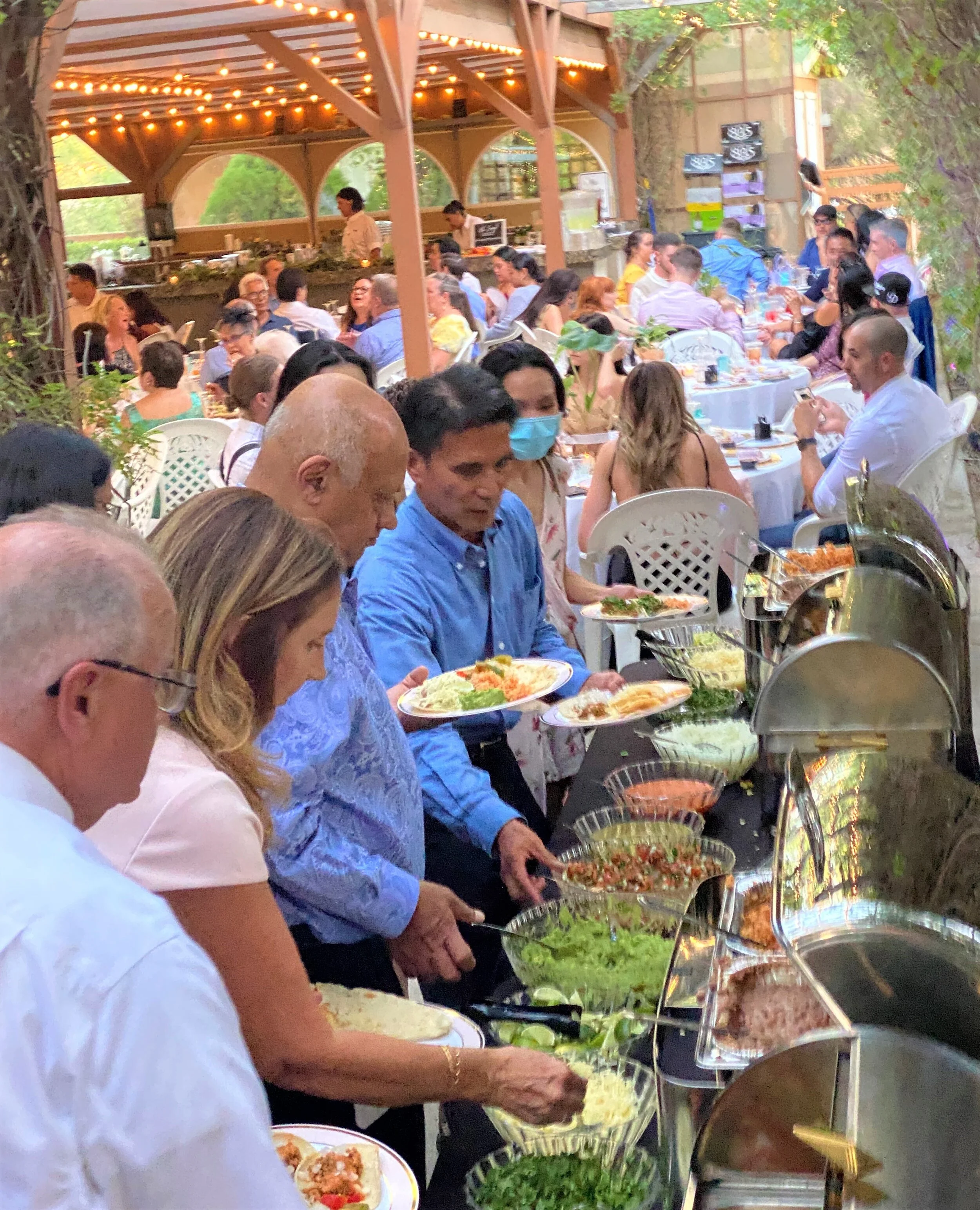 Guests enjoying a boutique self-serve taco bar at a Temecula wine country wedding, featuring fresh artisan ingredients