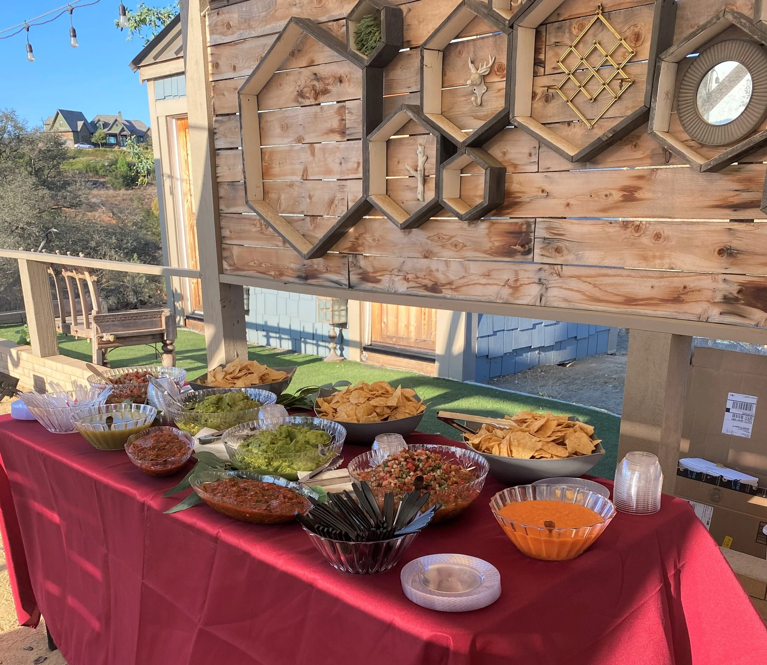 A massive artisan salsa bar featuring fresh guacamole, multiple authentic salsas, and endless tortilla chips displayed for a catered event by LaLa Tacos.