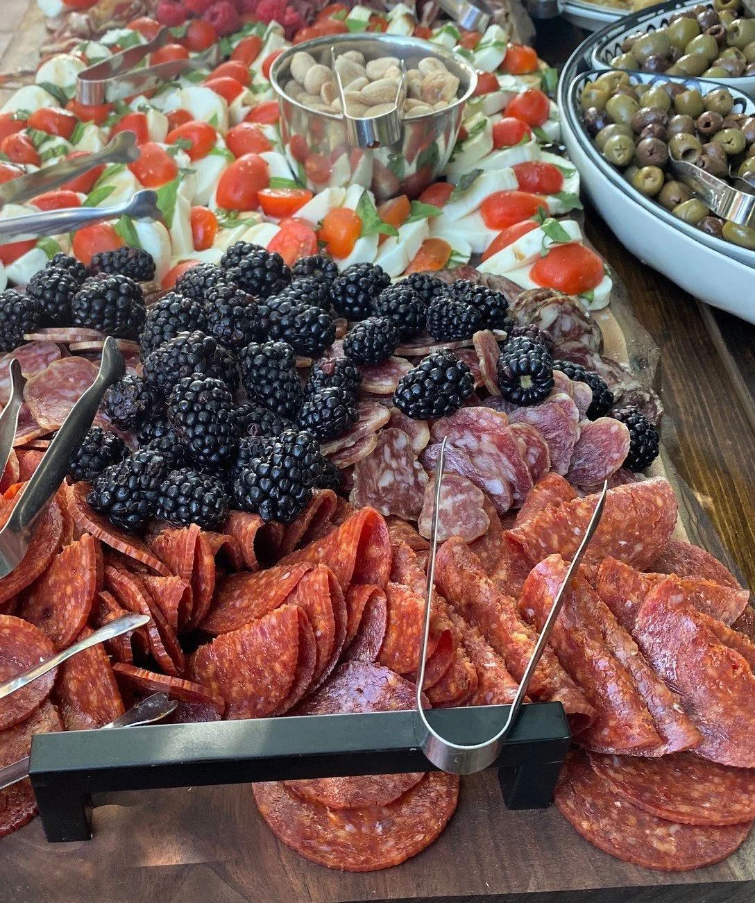 Artisan charcuterie board featuring premium cheeses and meats for a wedding cocktail hour, provided by boutique taco catering specialists