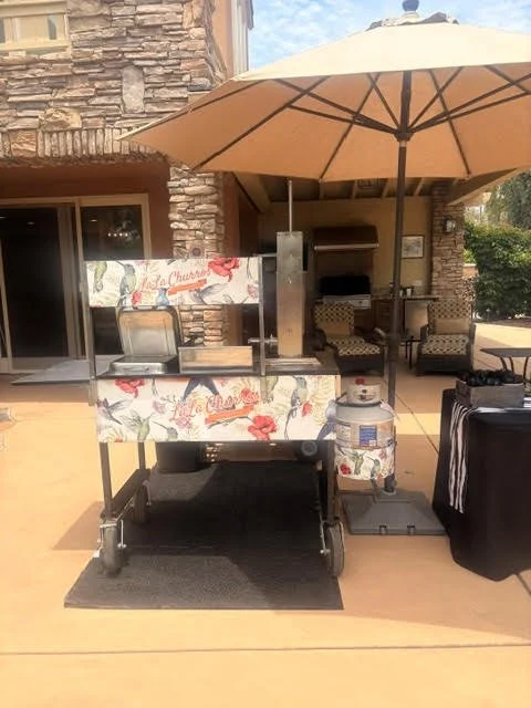 Disney recipe churro cart serving fresh cinnamon sugar churros during a Fourth of July celebration in San Diego, California for 150 guests. Fresh churros are prepared on-site as an interactive dessert catering experience.