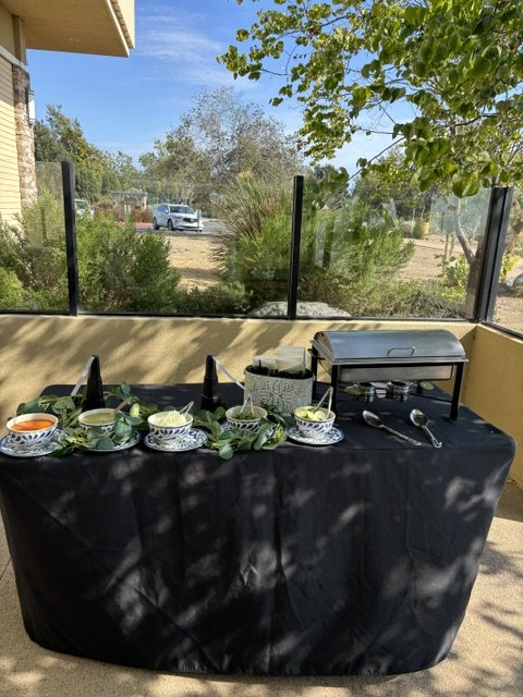 Taco bar at a Camp Pendleton retirement party featuring Mexican rice, refried beans, fresh toppings, homemade salsas, and traditional taco accompaniments.