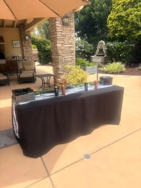 Churro toppings bar with chocolate and caramel drizzle served alongside Disney recipe churro catering during a Fourth of July celebration in San Diego, California. Guests customize their fresh churros with premium dessert toppings.