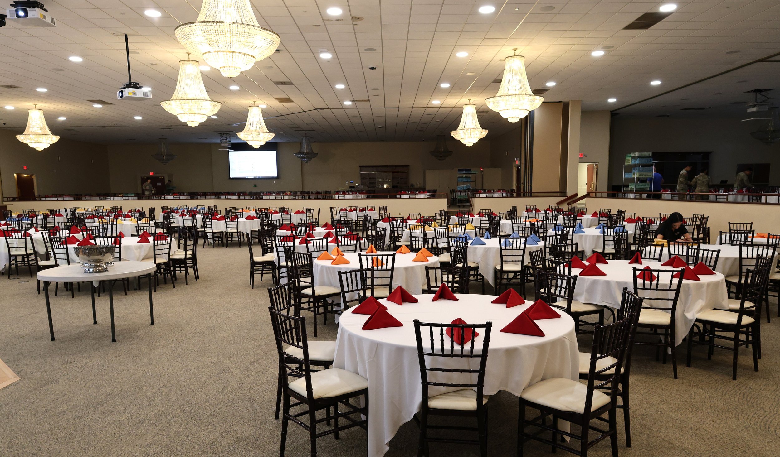 Large-scale banquet hall with chandeliers and formal table settings prepped for high-capacity catering by LaLa Tacos.