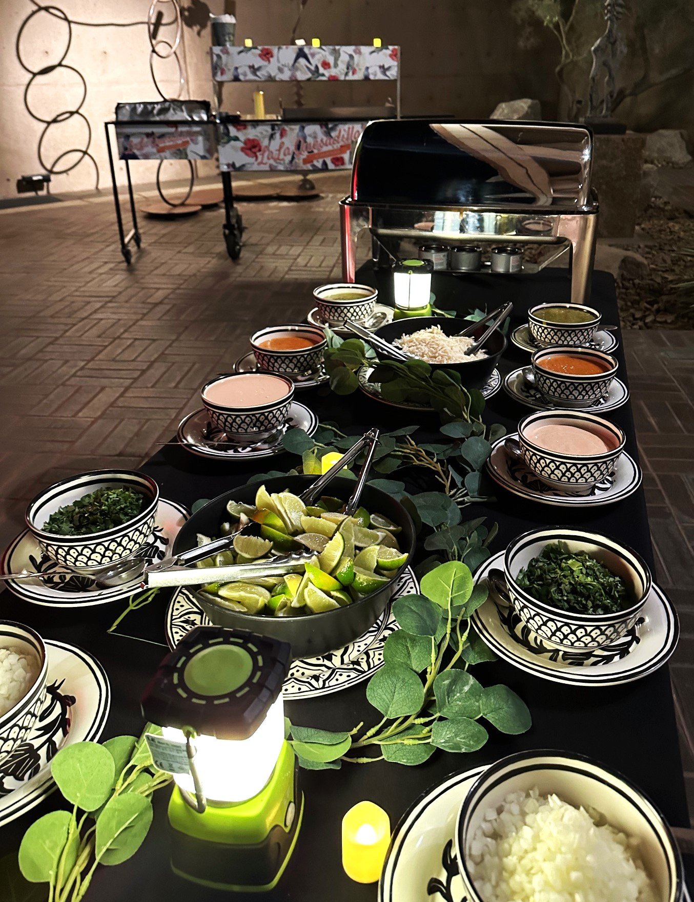Professional taco bar catering setup at a Coachella Valley event featuring fresh toppings, homemade salsas, and custom taco cart service by LaLa Tacos.