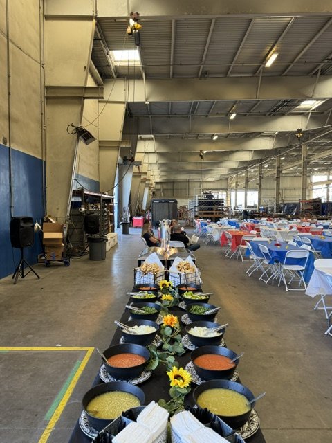 High capacity corporate taco catering buffet with artisan salsas set up inside a massive Irvine warehouse to serve 700 guests.