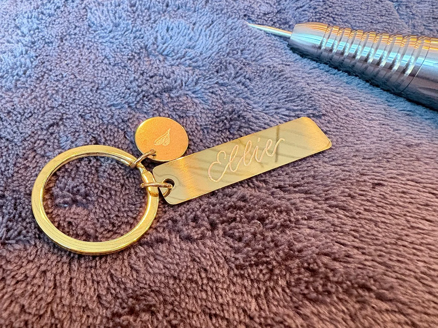Live engraving on metal key rings at Mollie's opening night in Manchester