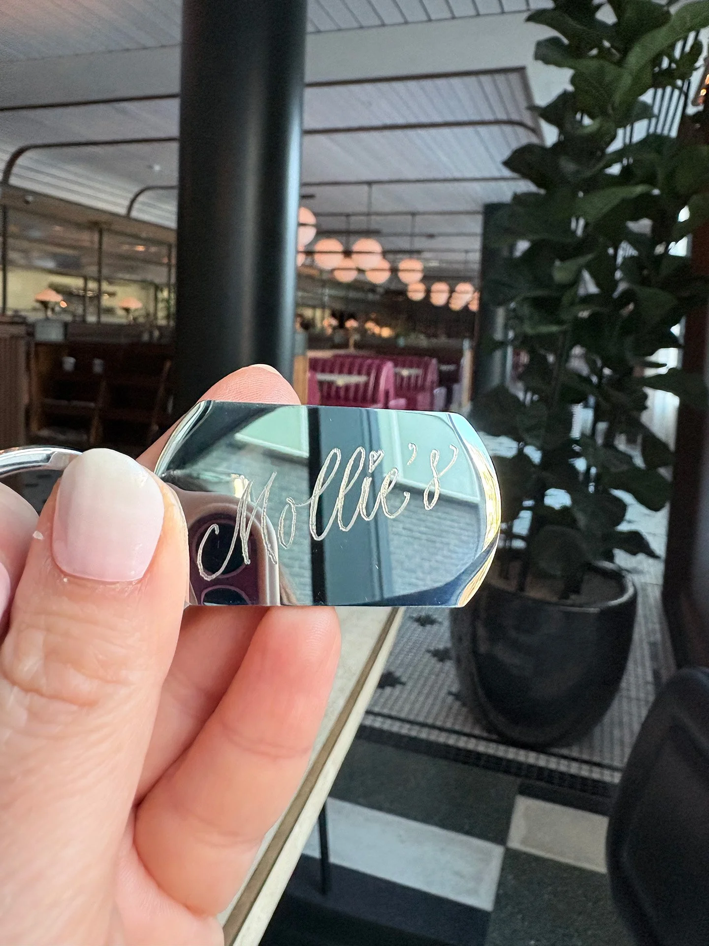 Live engraving on metal key rings at Mollie's opening night in Manchester