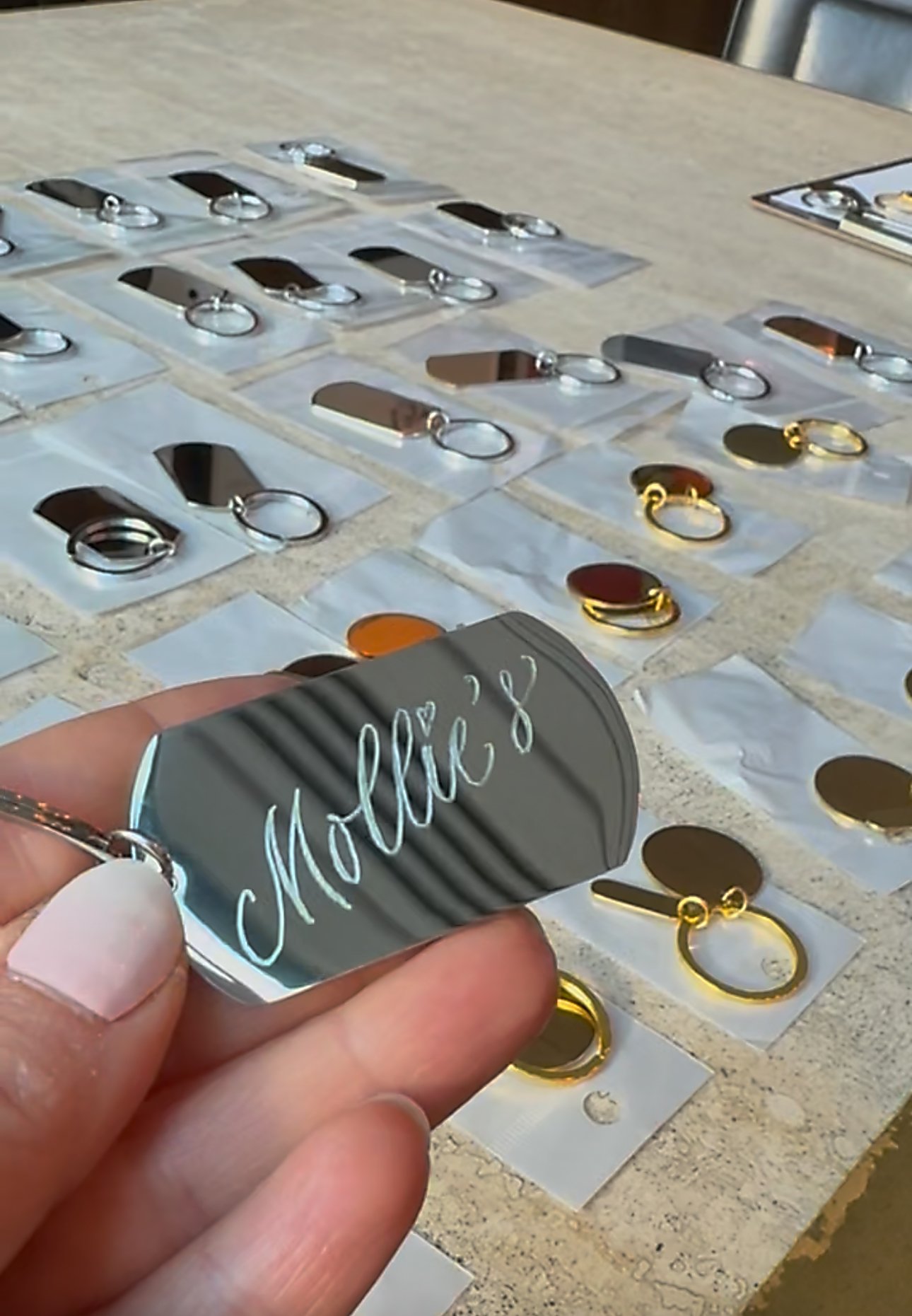 Live engraving on metal key rings at Mollie's opening night in Manchester