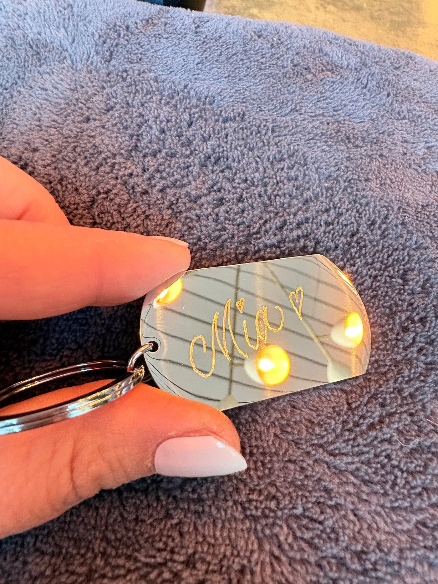Live engraving on metal key rings at Mollie's opening night in Manchester