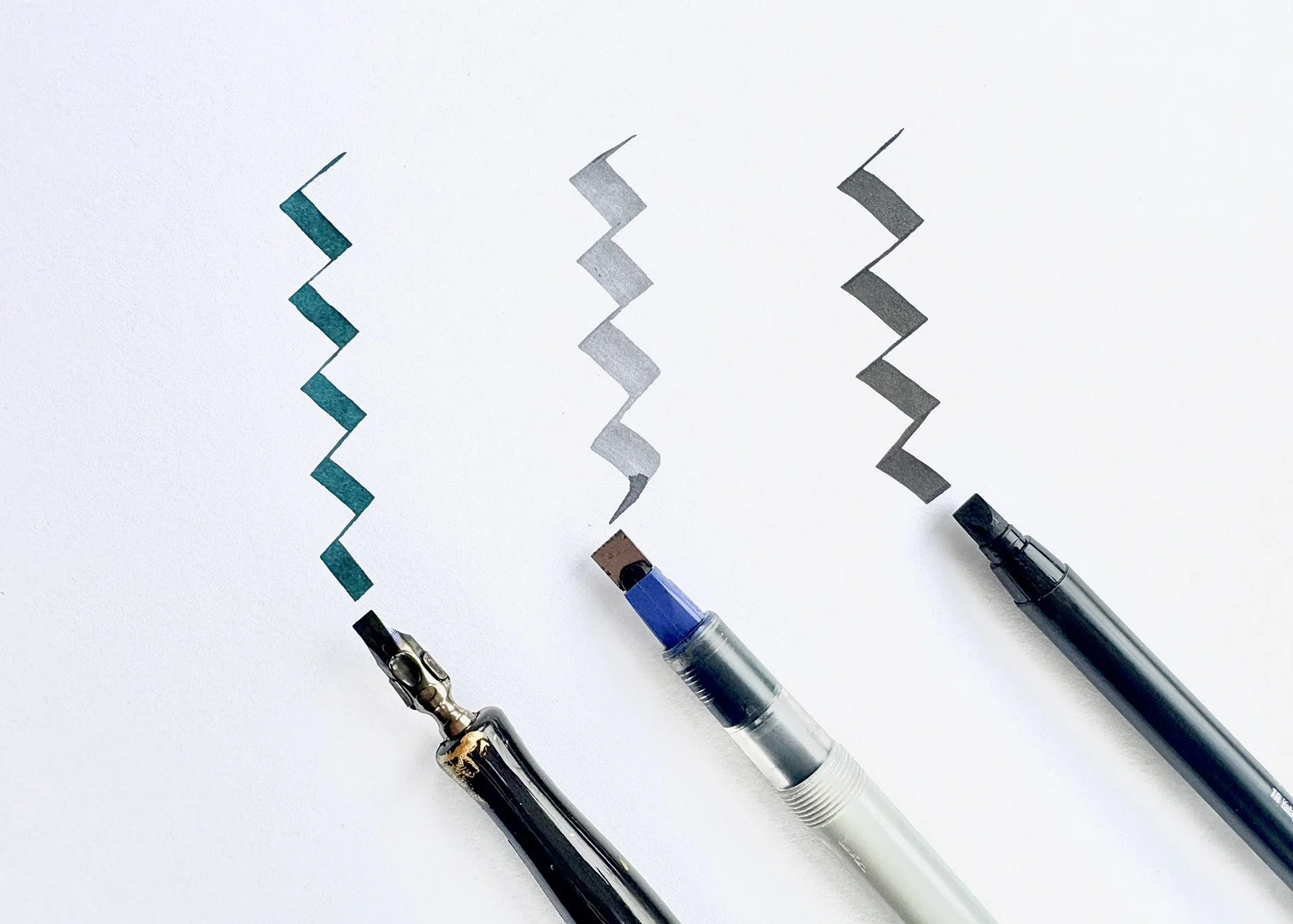 a broad nib pen, a Pilot parallel pen and a chisel-tip marker with the  thick and thin lines they produce.